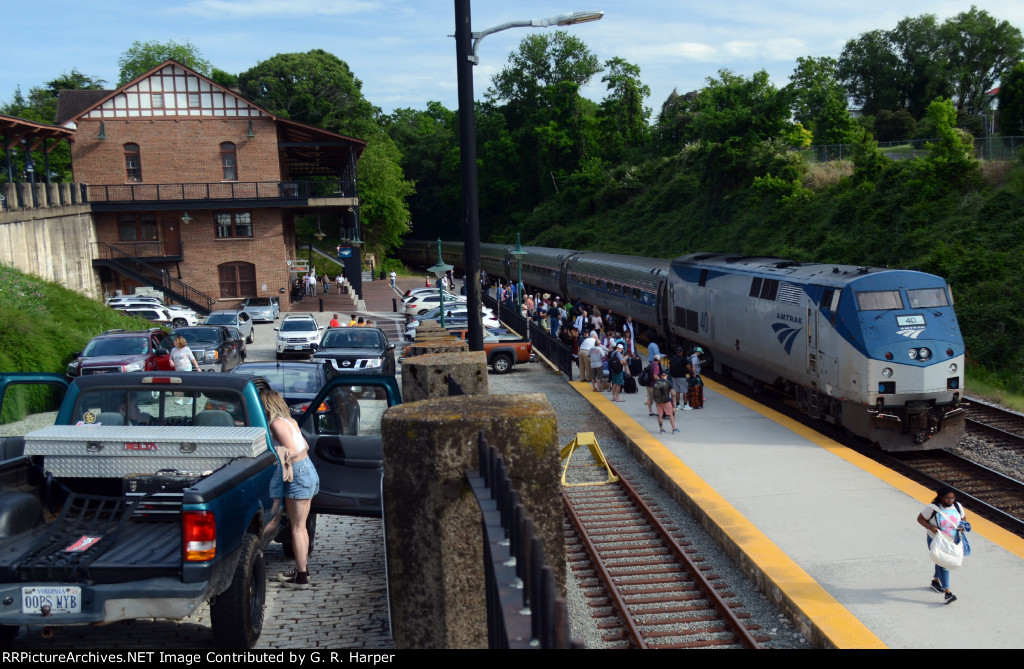 One lady unaware of how short tr. 66 is makes her way down the platform.  Train is only five cars long, compared to the eight or nine cars the morning Regional sports.  A 180 turn was made.